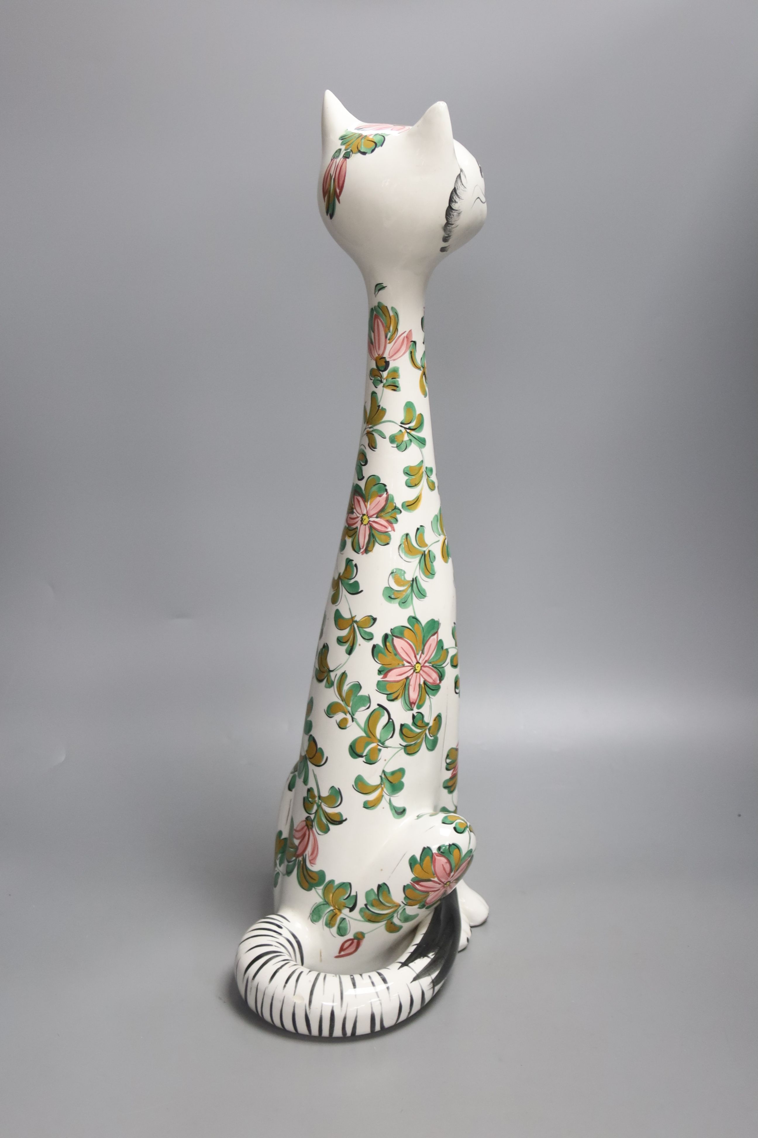 A tall Italian ceramic floral decorated cat, 57cm high